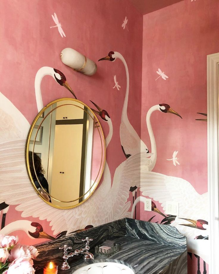 a room with a mirror and a swan mural on the wall