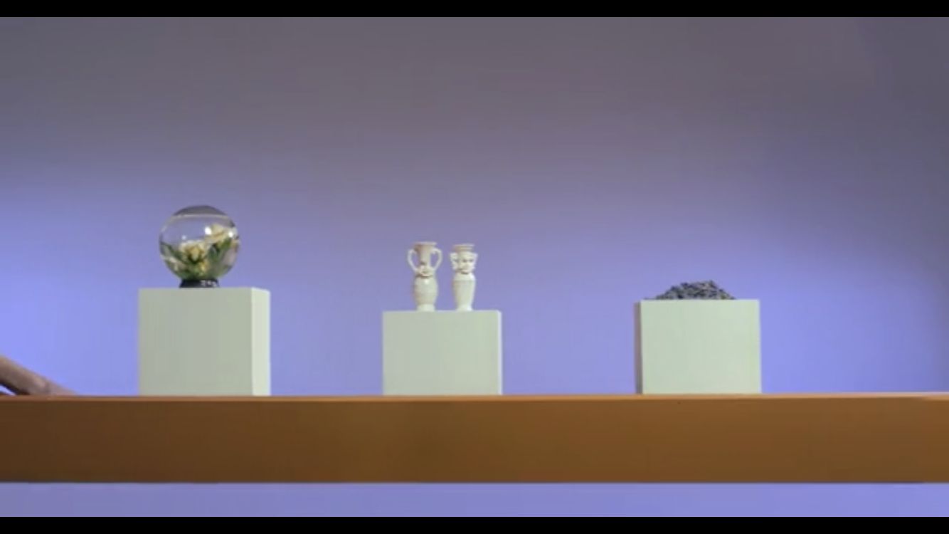 a shelf with three vases on top of it