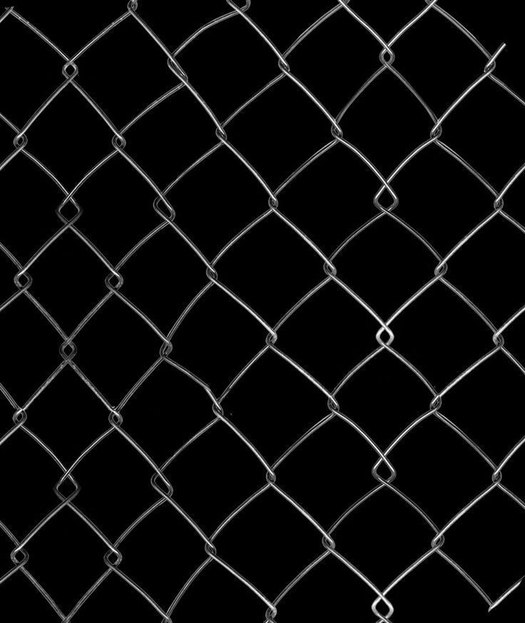 a black and white photo of a chain link fence