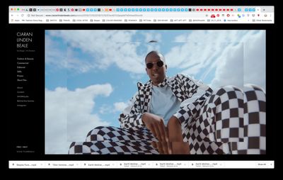 a man sitting on top of a checkered blanket