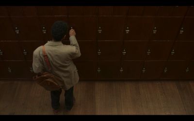 a person standing in front of a bunch of lockers