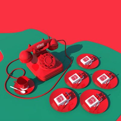 a red phone sitting on top of a green table