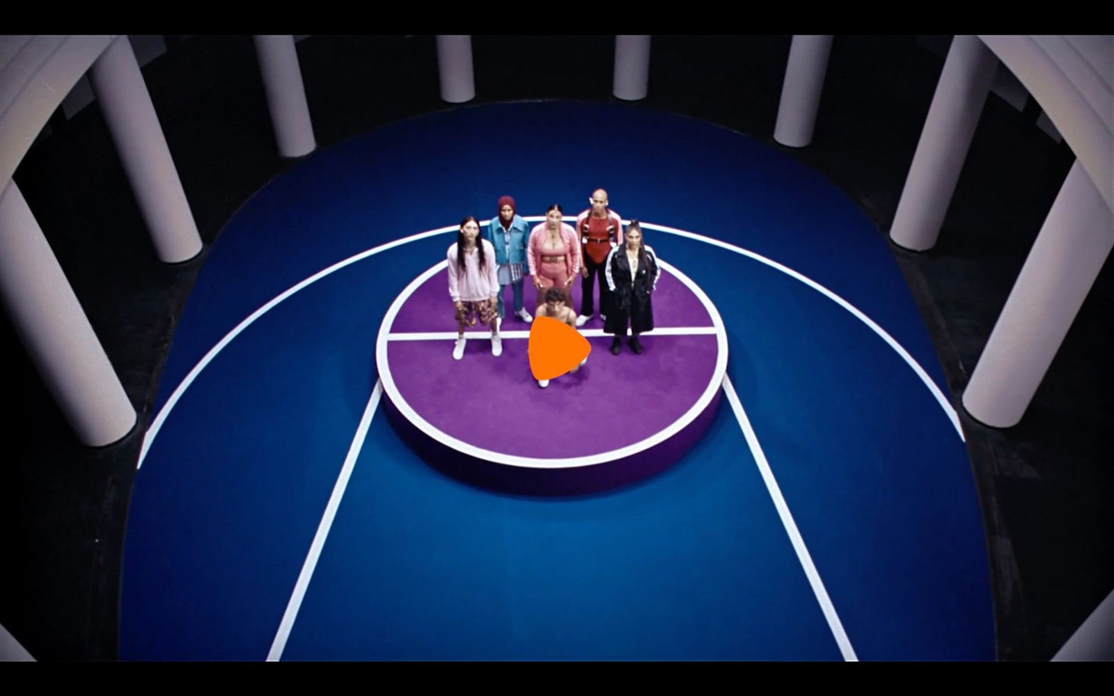 a group of people standing on top of a basketball court