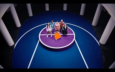 a group of people standing on top of a basketball court