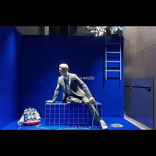 a mannequin sitting on top of a blue box