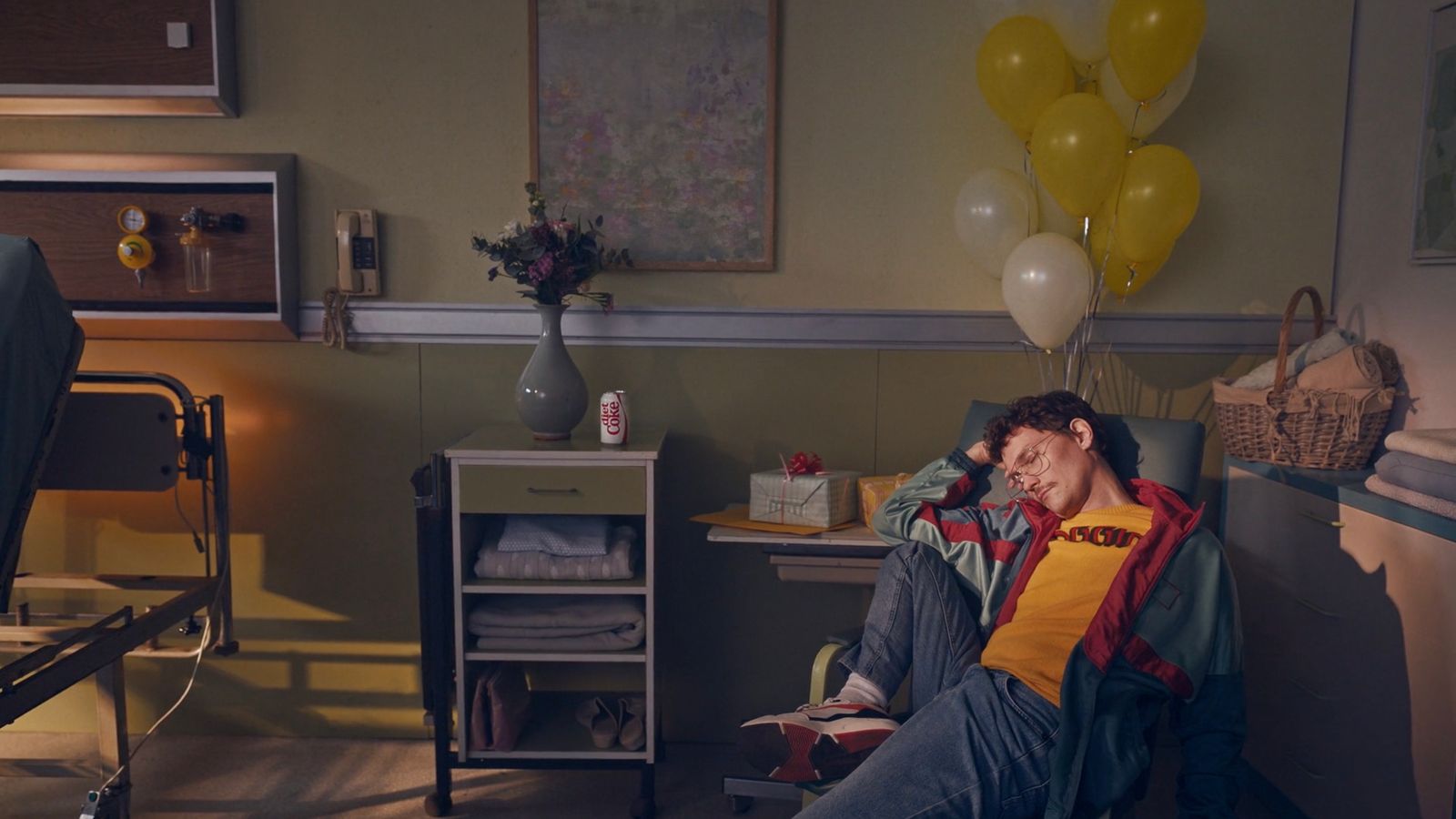 a man sitting in a room with a bunch of balloons