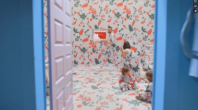 a woman taking a picture of a child in a bathroom