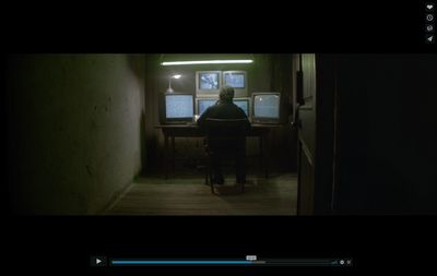 a person sitting at a desk in a dark room