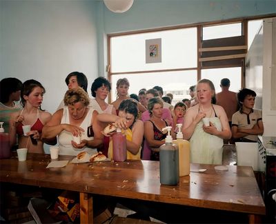 a group of people standing around a table