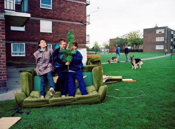 a group of people standing on top of an inflatable couch