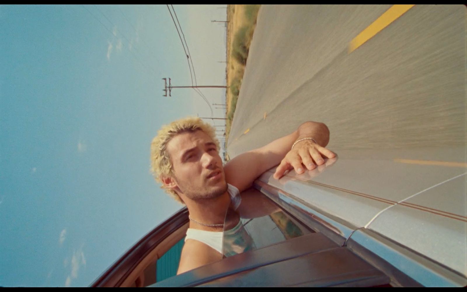 a man leaning out the window of a car