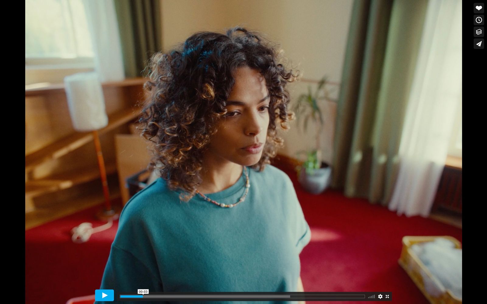 a woman with curly hair standing in a room