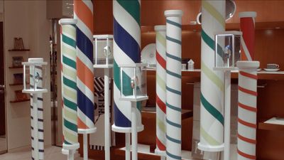 a group of colorful striped poles in a room