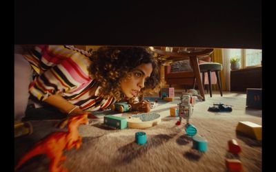 a woman laying on the floor surrounded by toys