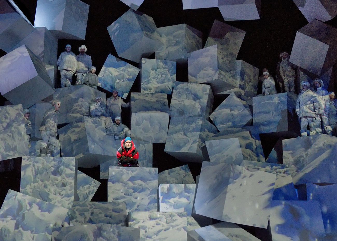 a group of people standing on top of a pile of cubes