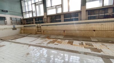 an empty swimming pool with tiled floors and walls