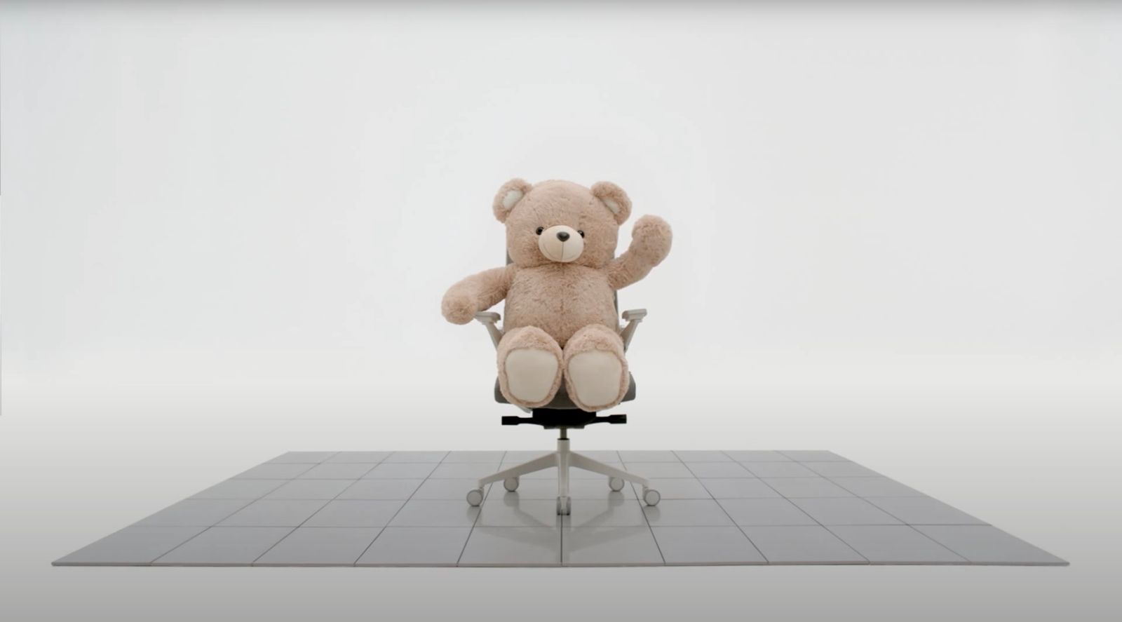 a teddy bear sitting on top of an office chair