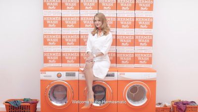 a woman sitting on top of a stack of washers