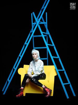 a person sitting on a yellow chair with a ladder