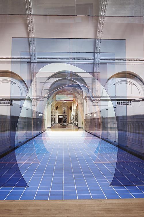 a hallway with a blue tiled floor and arches