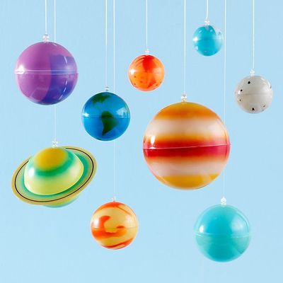 a group of different colored balls hanging from strings