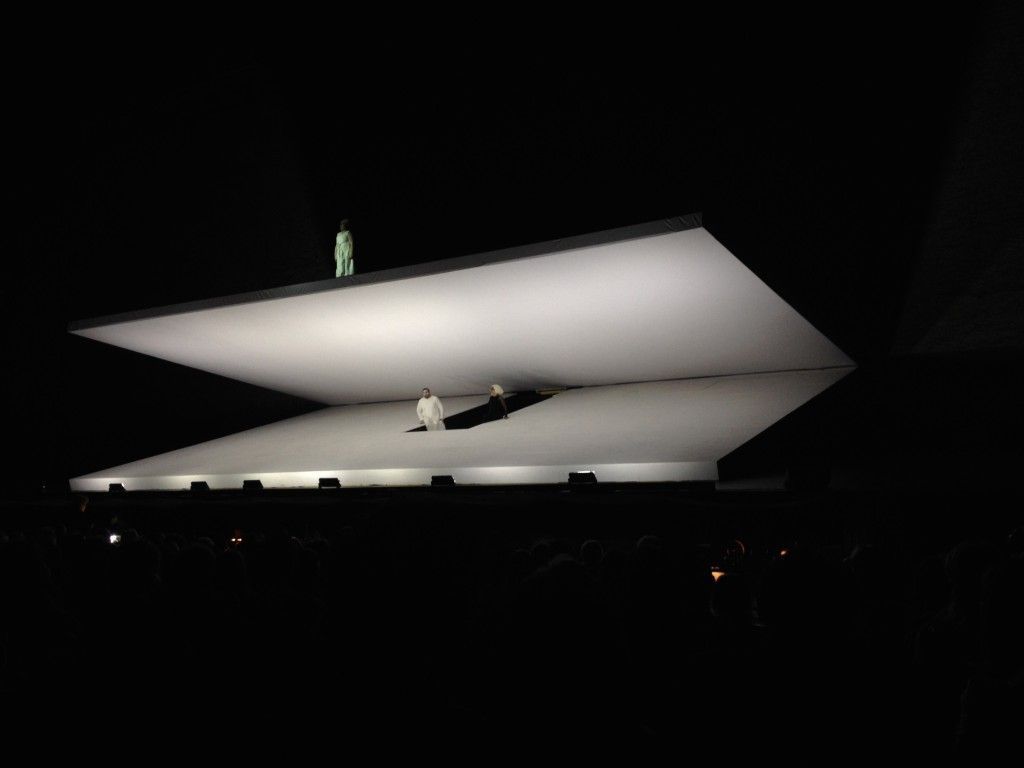 a man standing on top of a large white object