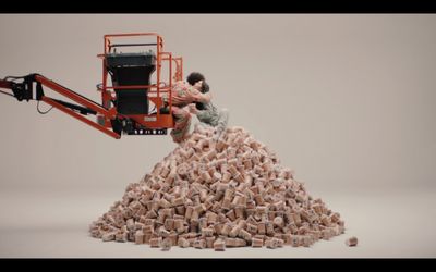 a man sitting on top of a pile of bricks