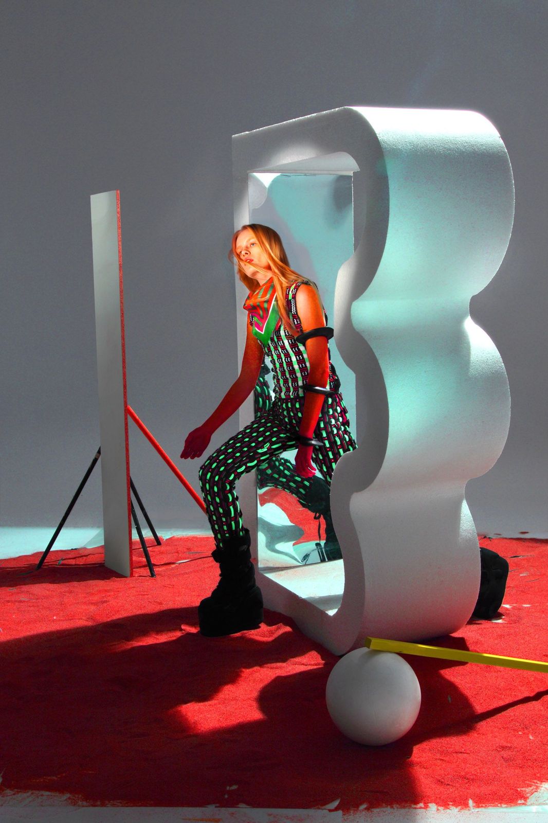 a woman sitting on top of a white sculpture