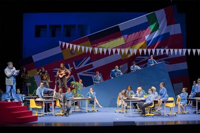 a group of people sitting around a table on a stage