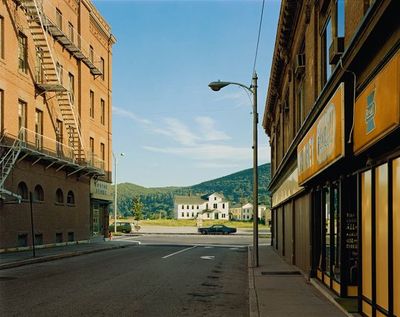 an empty street in front of a large building