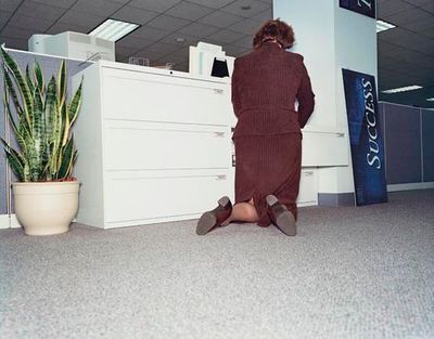 a woman sitting on the floor in an office