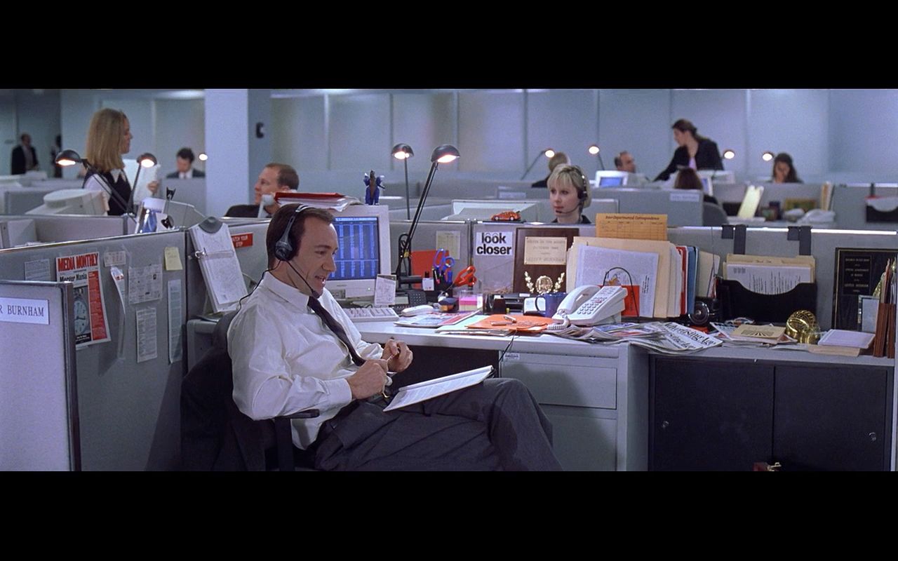 a man sitting at a desk in an office