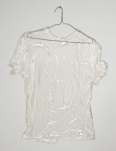 a white shirt hanging on a hanger