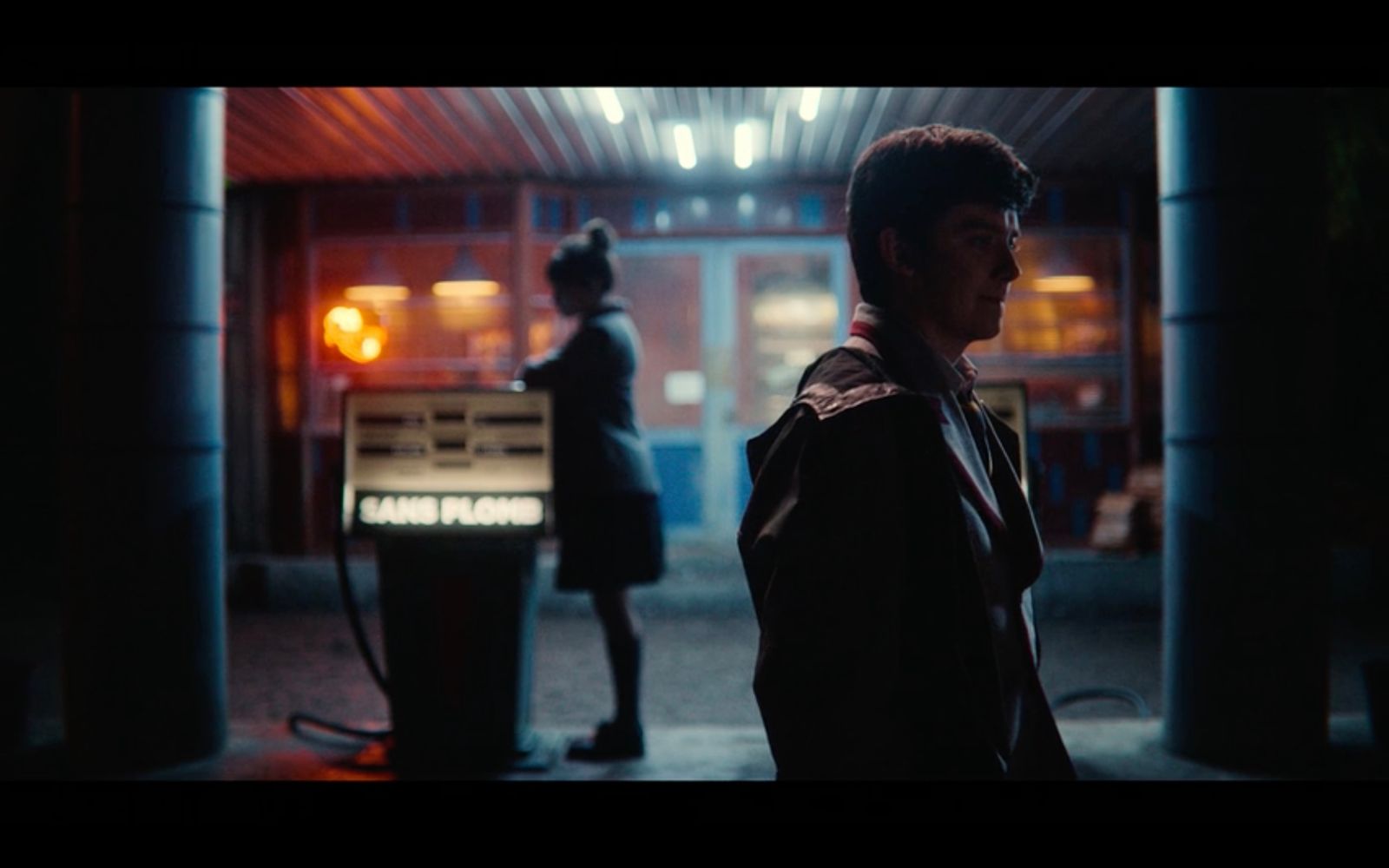 a man standing in front of a gas station