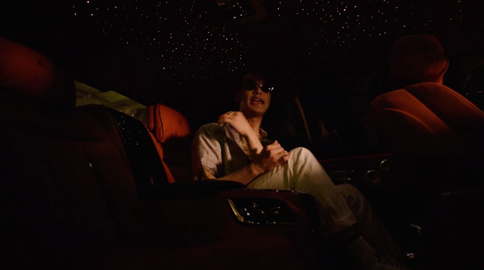 a man sitting in a car in the dark