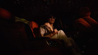 a man sitting in a car in the dark