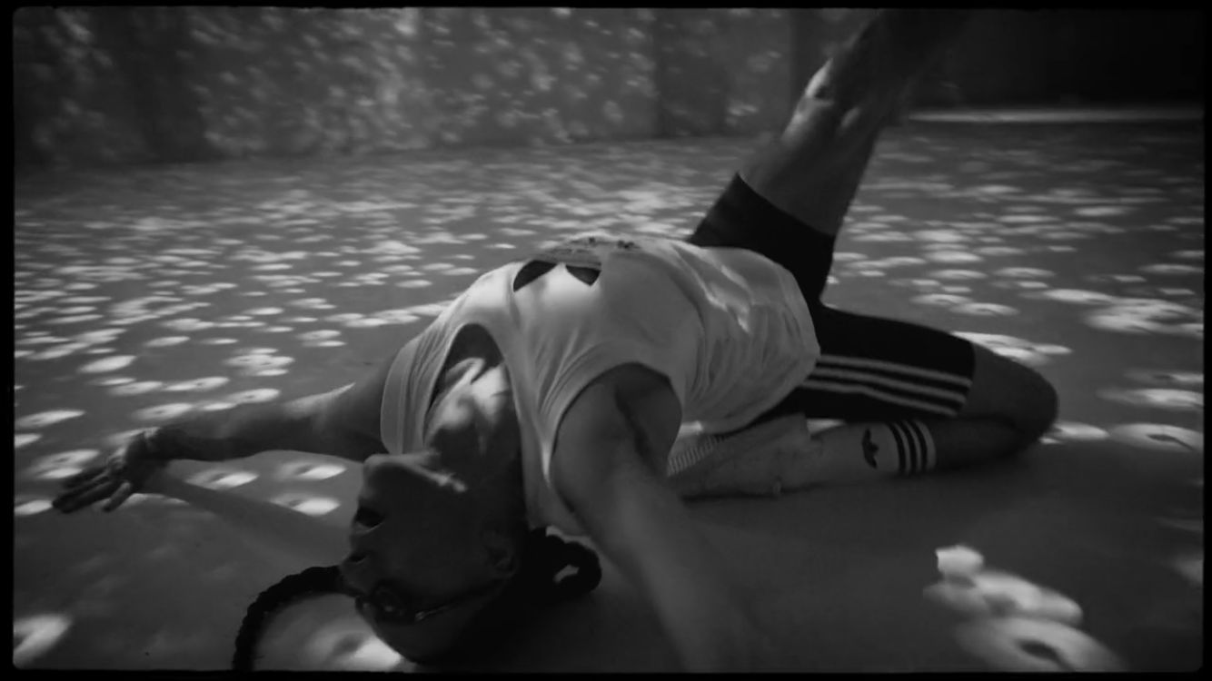 a man laying on the ground in the water