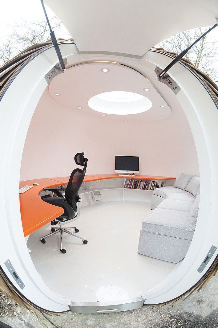 a room with a couch, desk, chair, and computer monitor