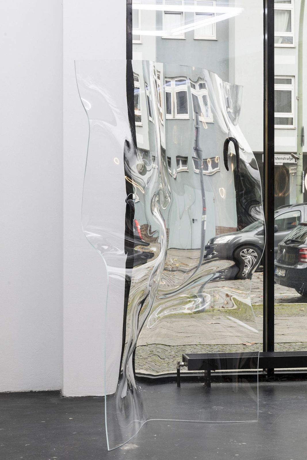 a glass sculpture of a woman in front of a window