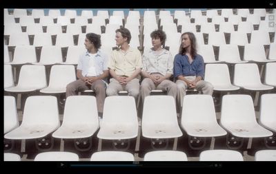 a group of people sitting next to each other in a stadium