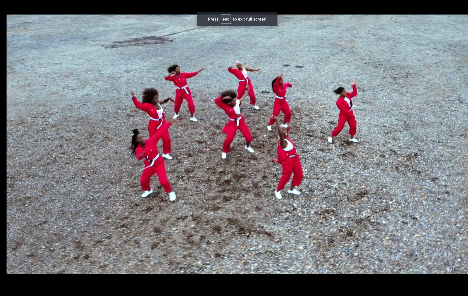 a group of people in red and white outfits