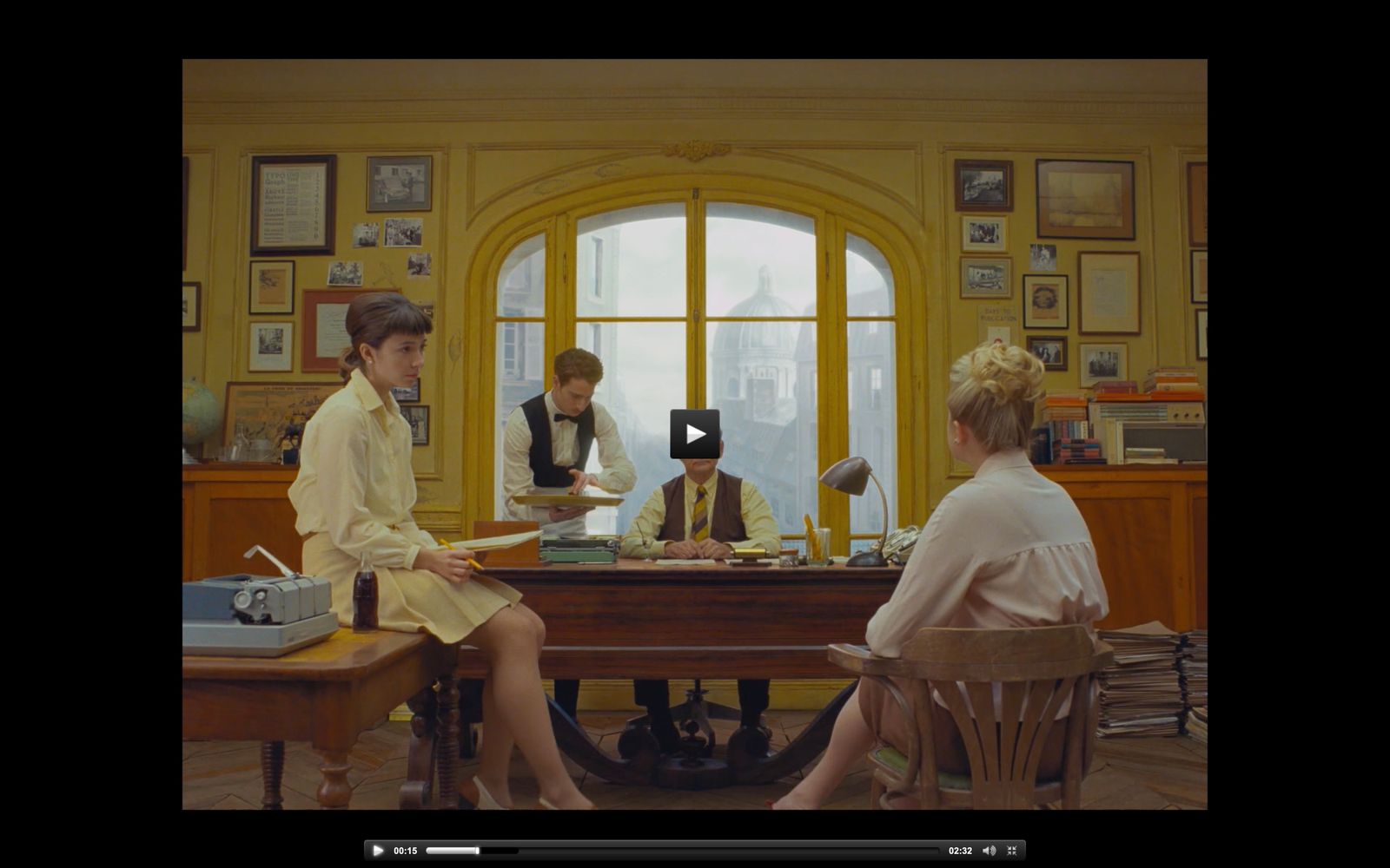 two women sitting at a table in front of a window