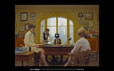 two women sitting at a table in front of a window