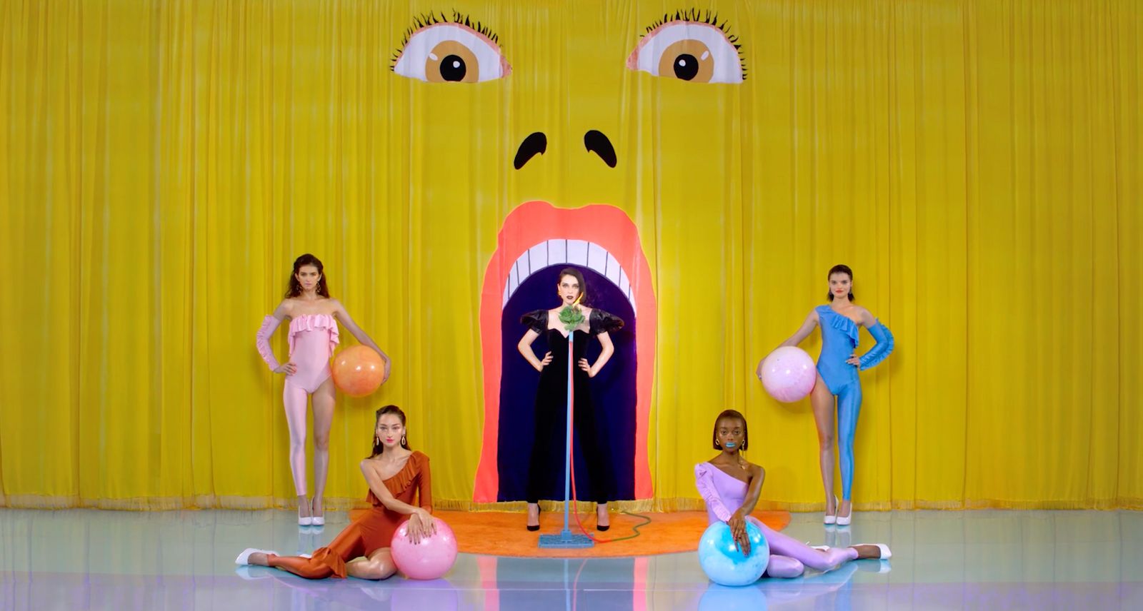 a group of women standing on top of a stage