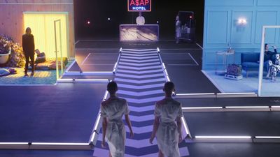 a couple of women walking down a runway