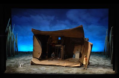 a man standing in front of a tent on a stage