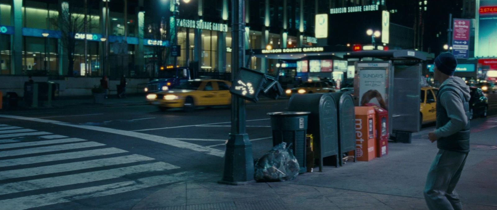 a man standing on the side of a street next to a traffic light