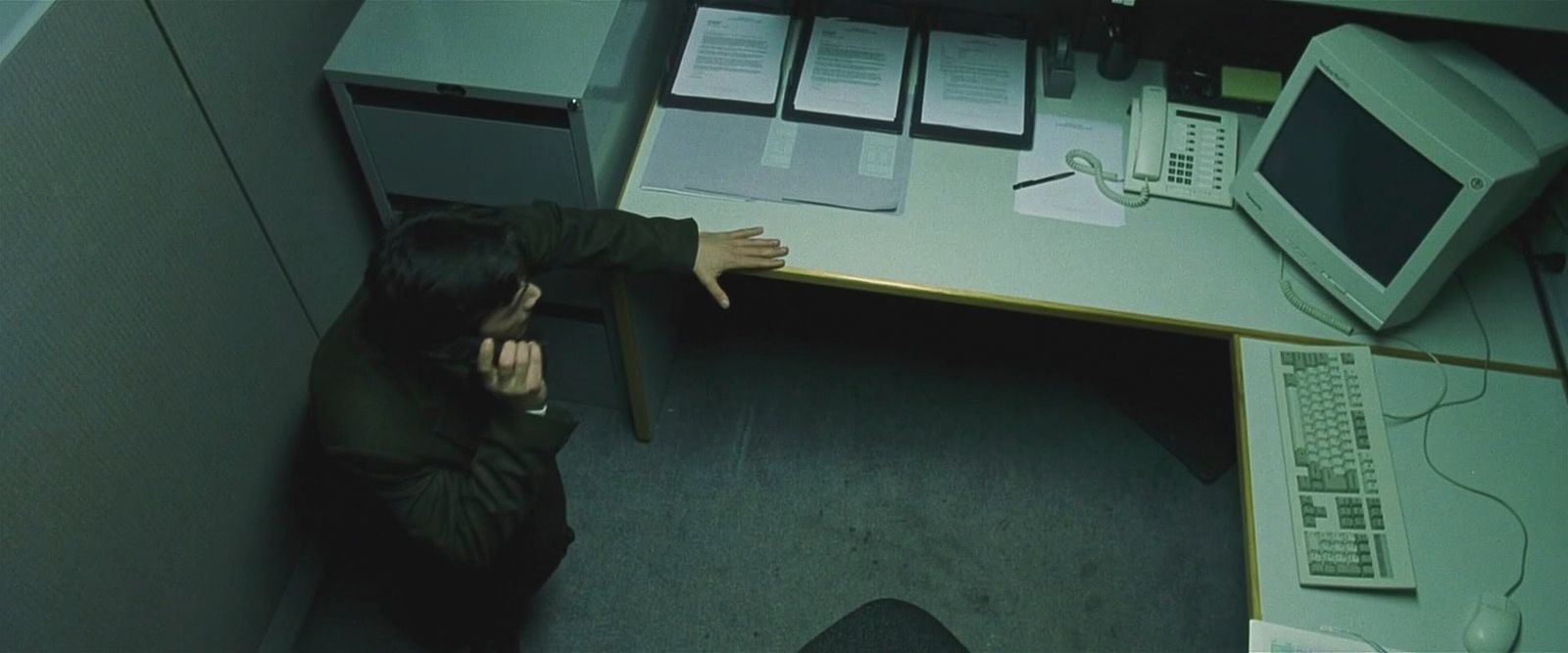 a person sitting at a desk with a computer