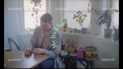 a man sitting at a table writing on a piece of paper