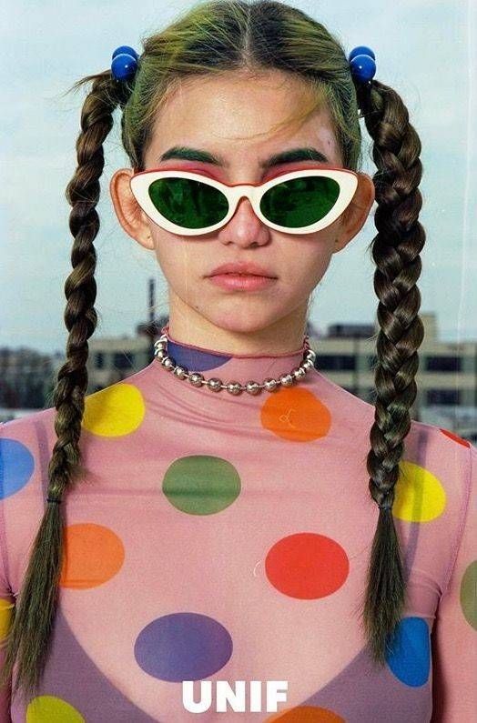 a woman wearing sunglasses and a polka dot shirt